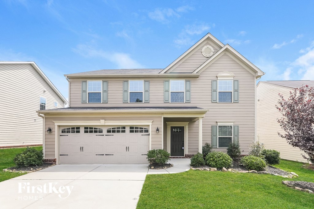 a beige house with a white garage door