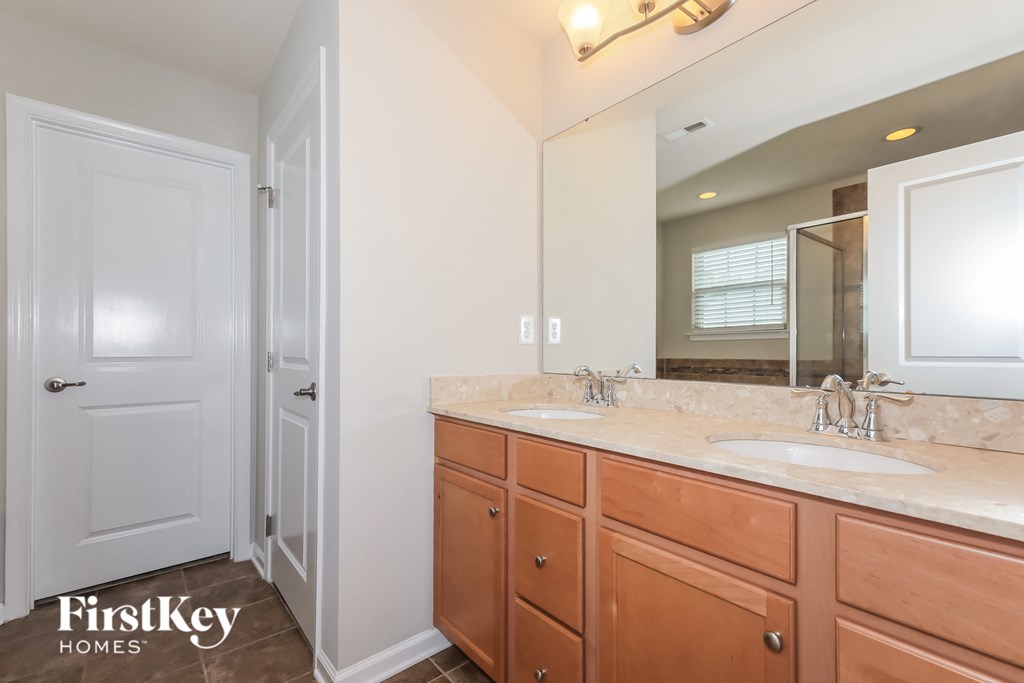 a bathroom with two sinks and a large mirror