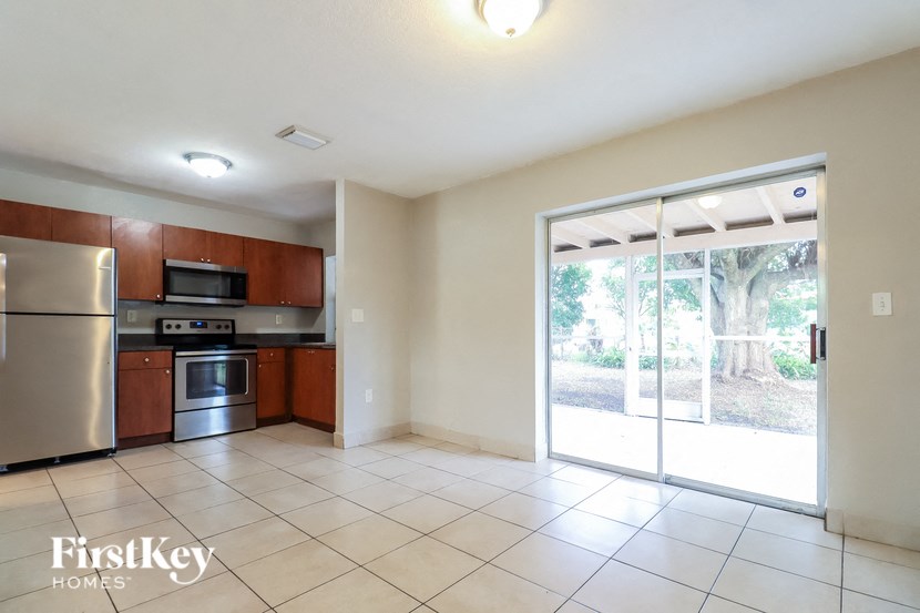 a kitchen with a sliding glass door leading to the backyard
