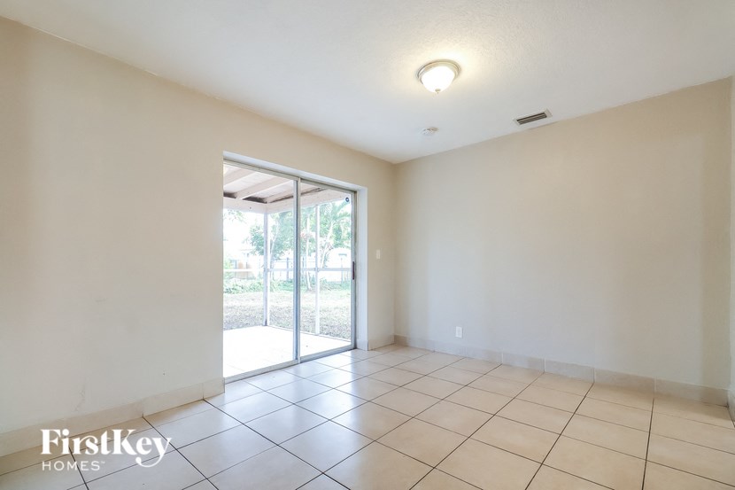 an empty living room with sliding glass doors to a patio