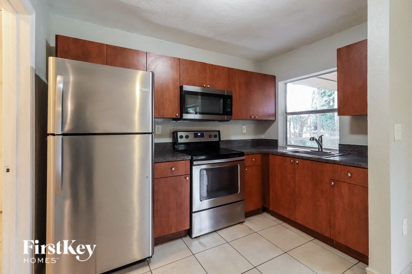 a kitchen with stainless steel appliances and wooden cabinets