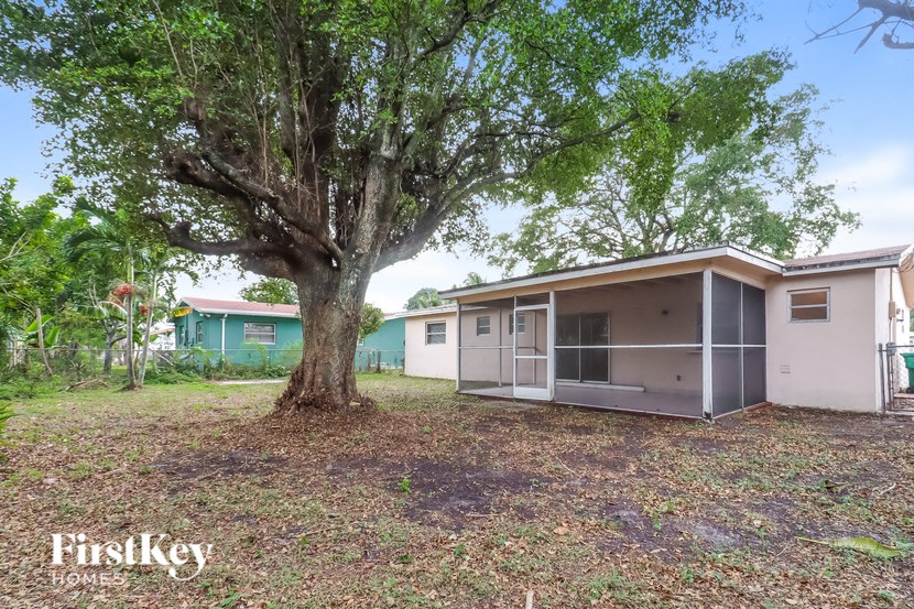 a small house with a large tree in front of it