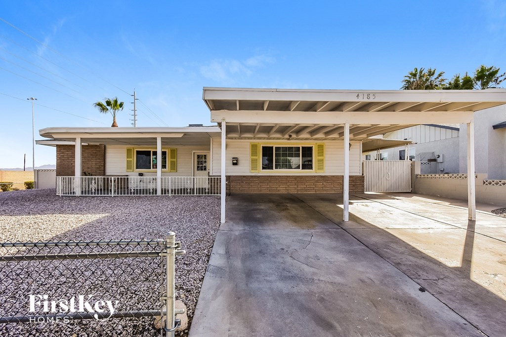 A house with a palm tree in the background.