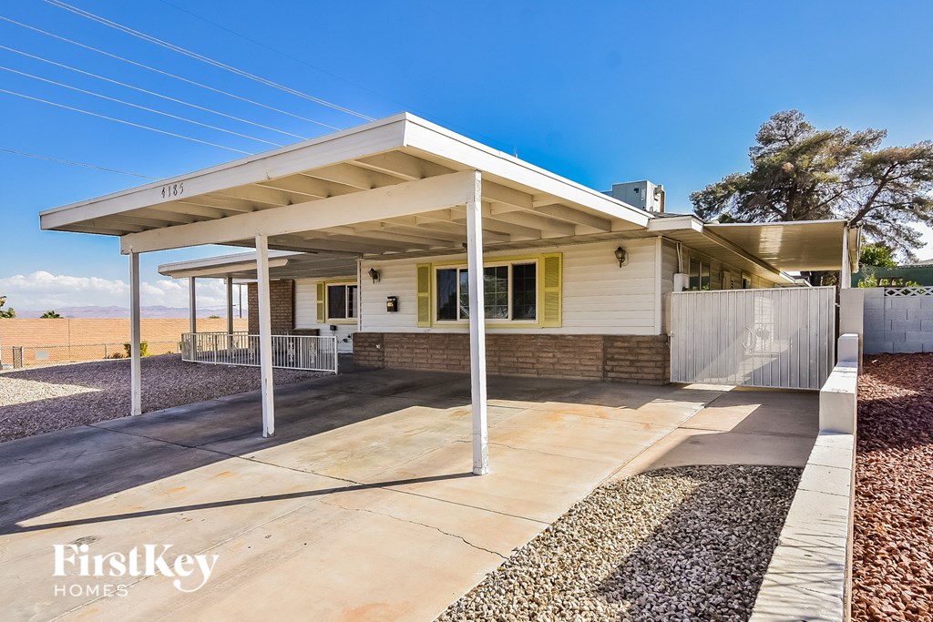 A house with a white roof and a porch is for sale.