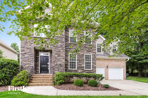 A house with a black front door and a garage door.
