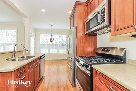 A kitchen with wooden cabinets and stainless steel appliances.