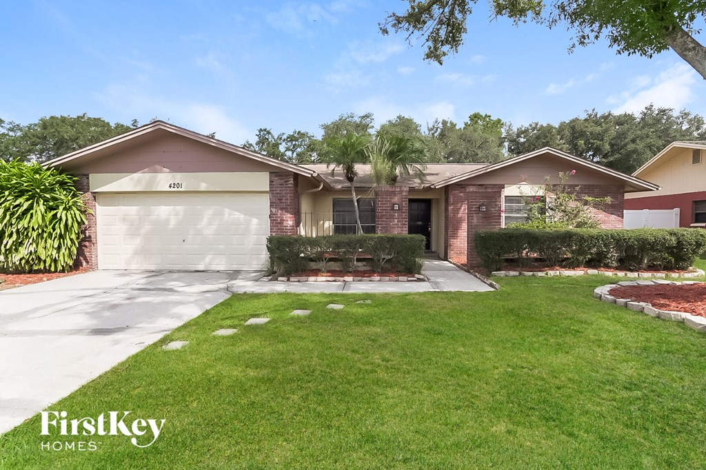 a home with a lawn and a garage