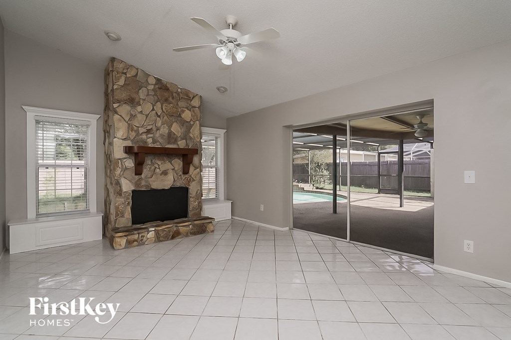 a living room with a fireplace and a tile floor