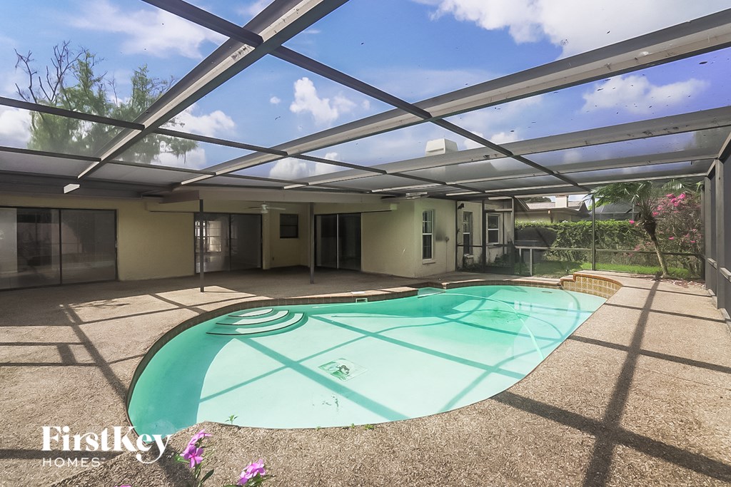 a large pool is under a glass roof in a house