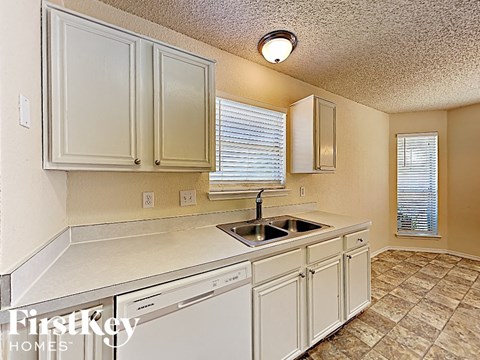 A kitchen with a sink and a dishwasher.