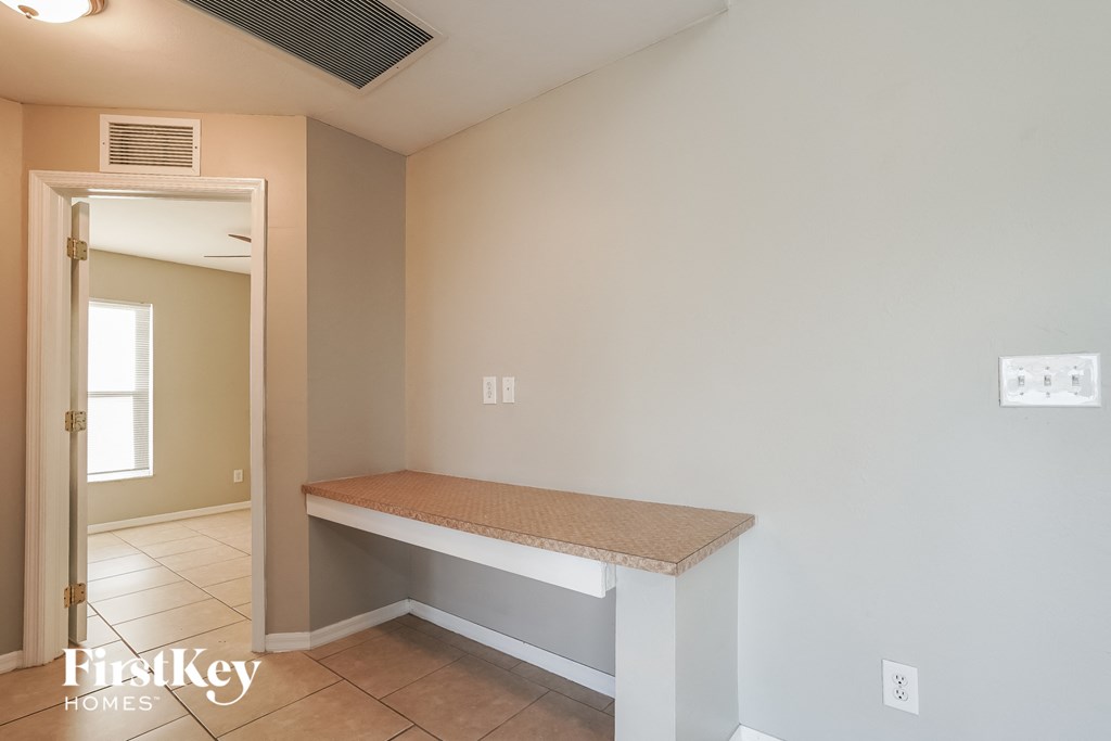 A room with a bench and a door leading to another room.