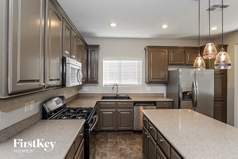 a kitchen with granite counter tops and stainless steel appliances