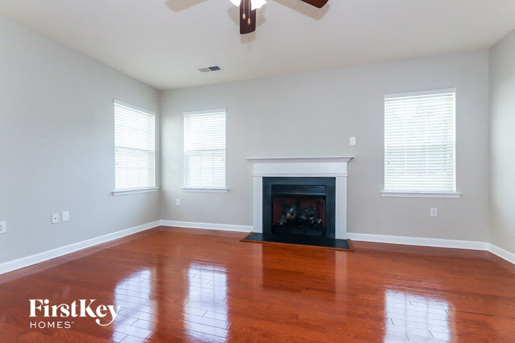 a living room with wood floors and a fireplace