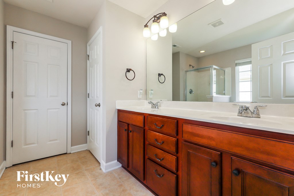 a bathroom with a large vanity and a large mirror