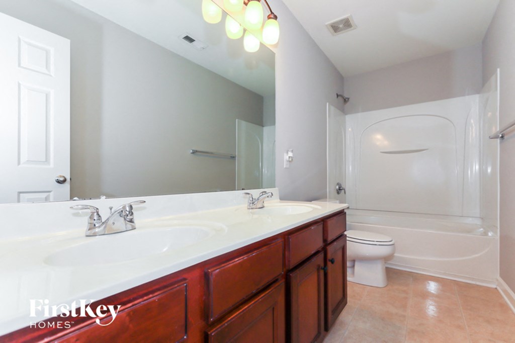 a bathroom with a sink and a toilet and a mirror