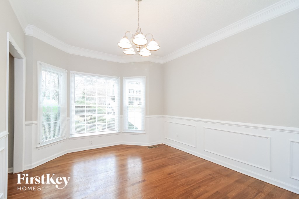 A room with wooden floors and white walls.