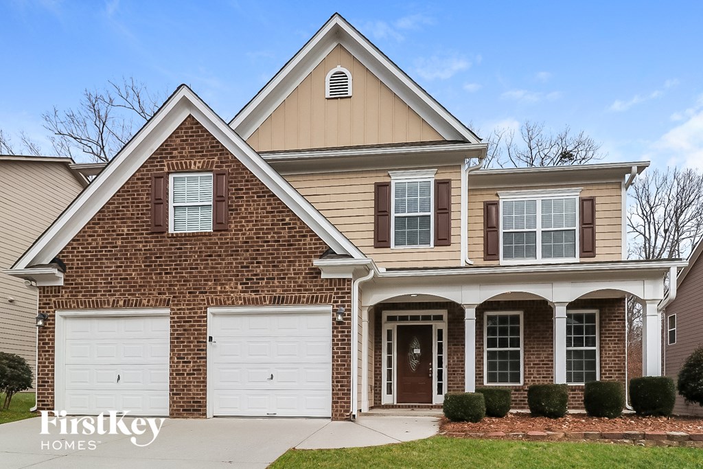 a large brick house with two garage doors