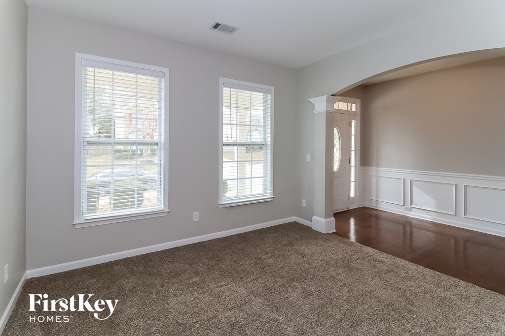 the living room after remodeling with carpet and windows