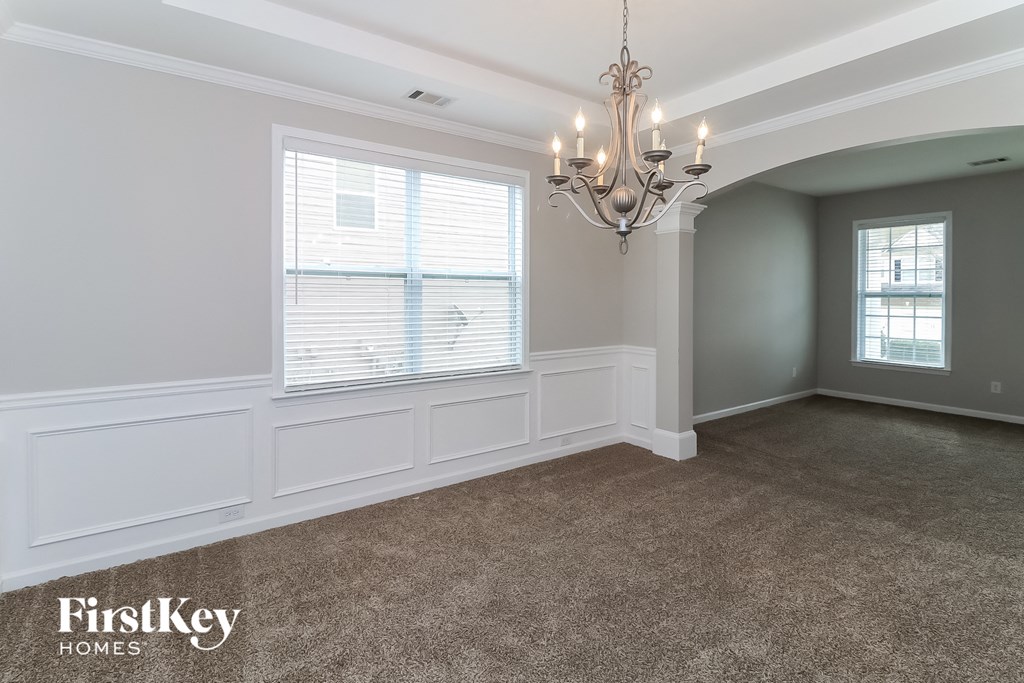 a dining room with a chandelier and a window