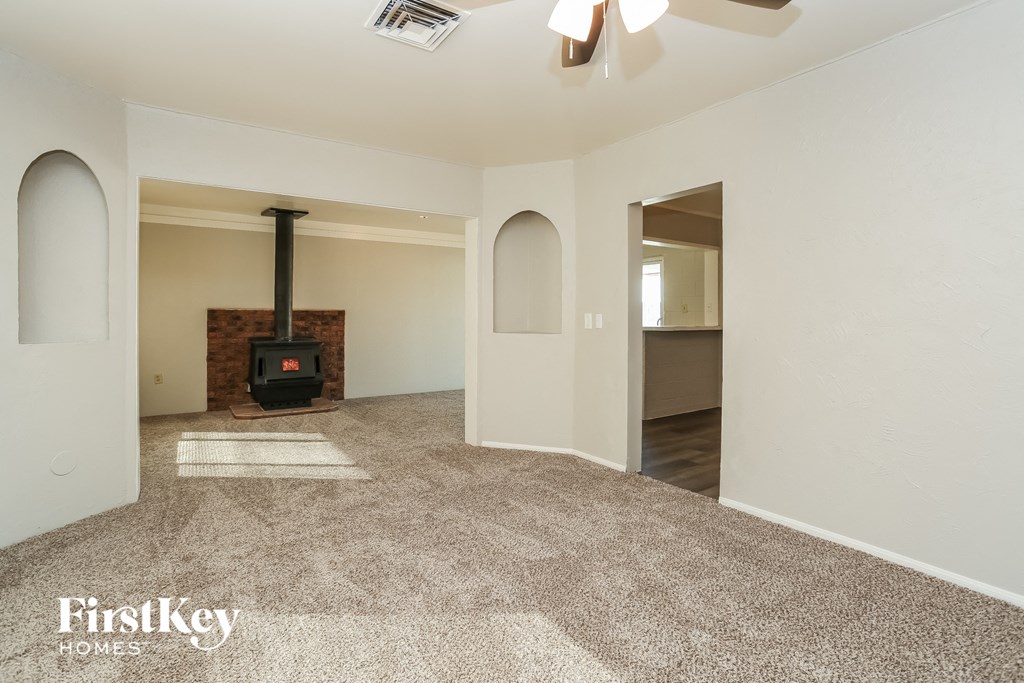 A room with a fireplace and a carpet.