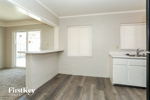A kitchen area with a white counter and cabinets.