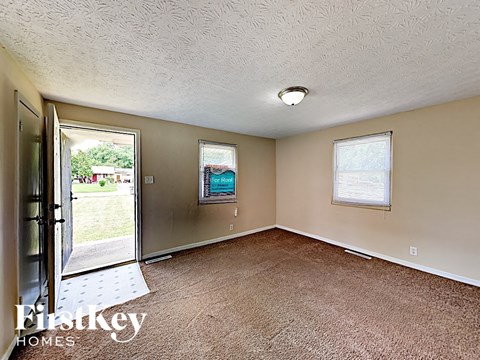 A room with a carpet floor and a window.
