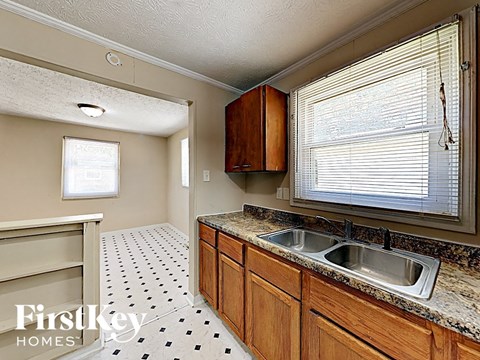 A kitchen with a sink and a window.