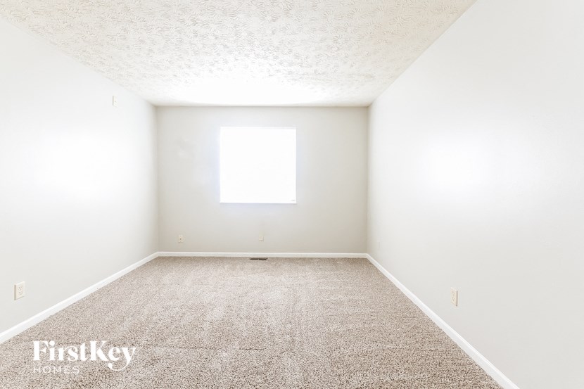 a empty room with white walls and a window