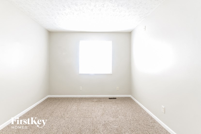 a empty room with white walls and a window