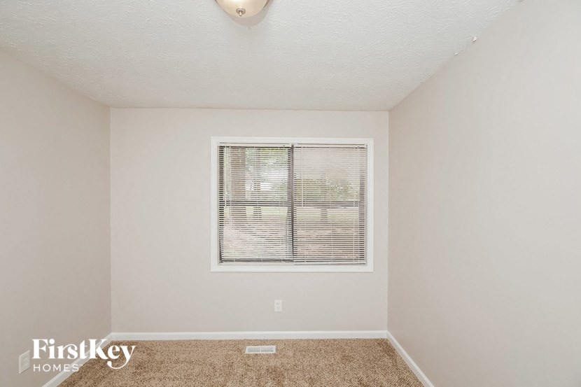 a room with a window and a carpet