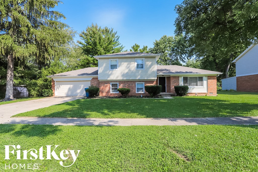 A house with a lawn in front of it and the words "FirstKey Homes" on the bottom.
