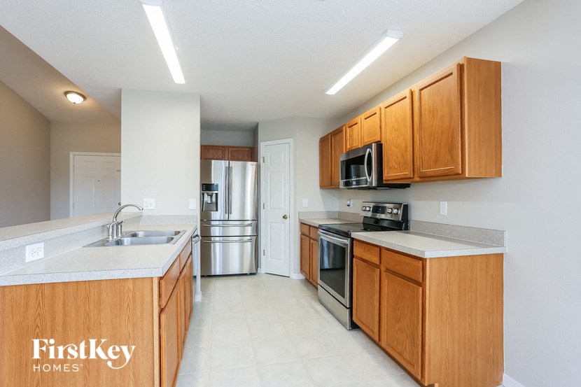 a kitchen with wooden cabinets and stainless steel appliances