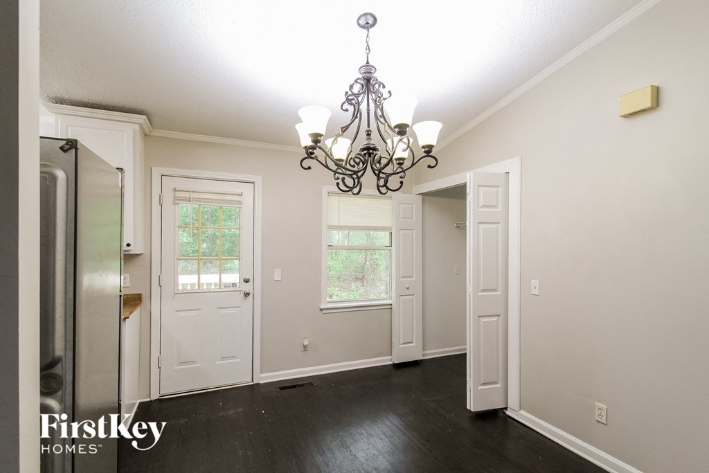 the kitchen and dining room of a home with a chandelier