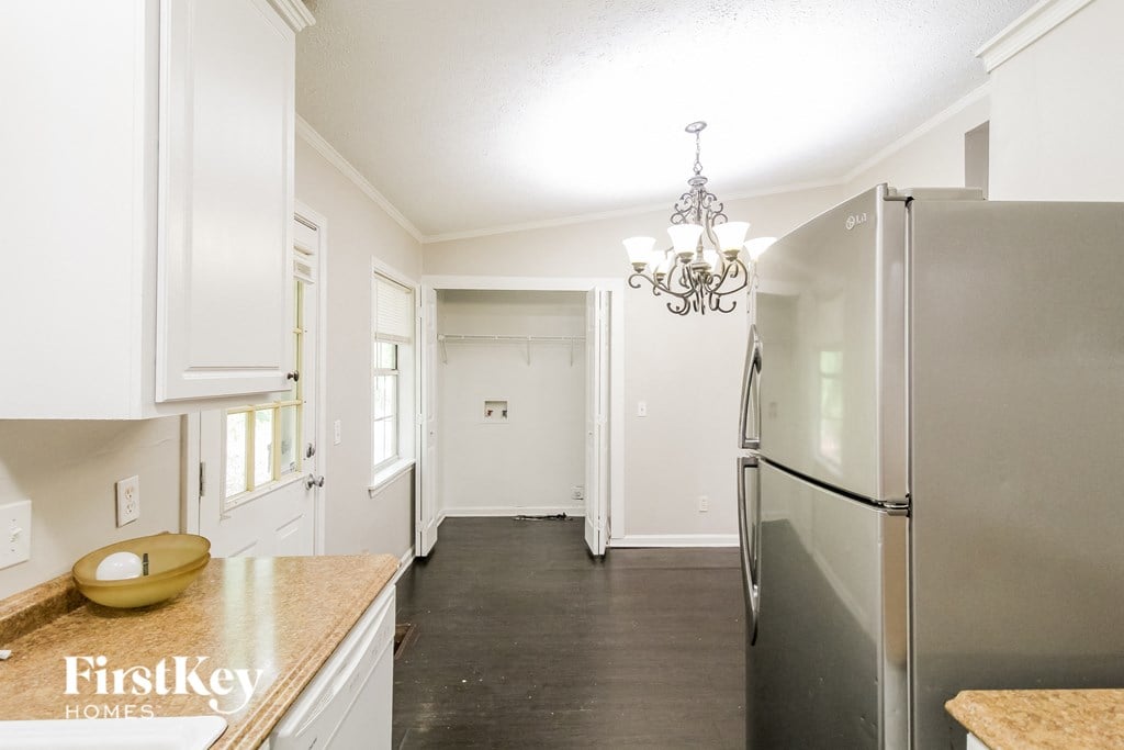a kitchen with stainless steel appliances and white cabinets