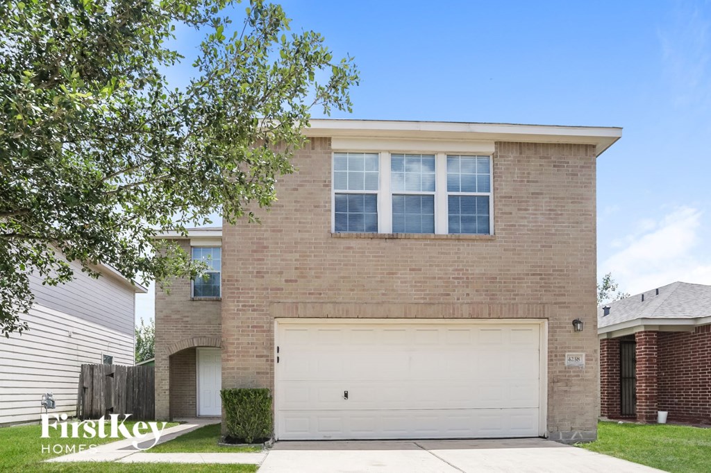 a brick house with a white garage door