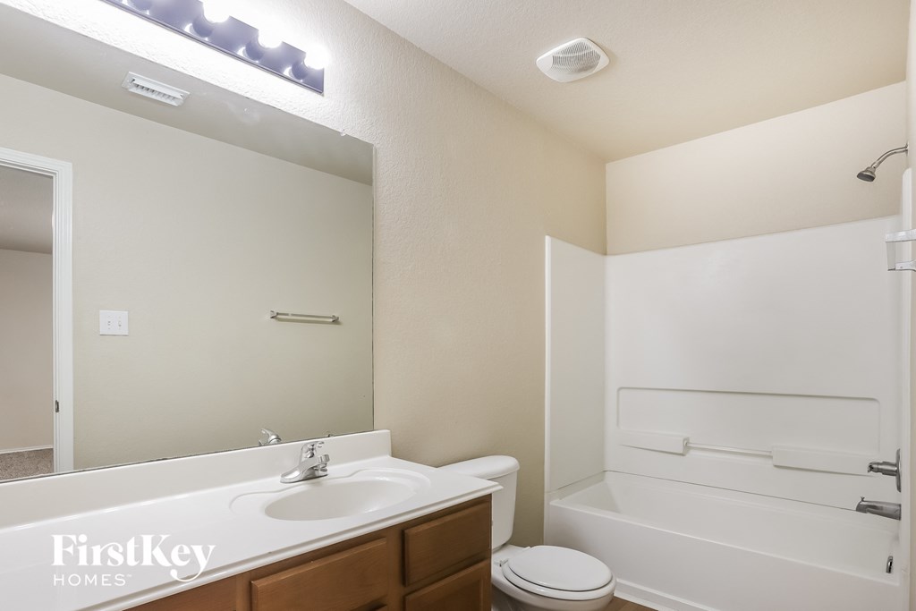 a bathroom with a sink and a toilet and a bath tub