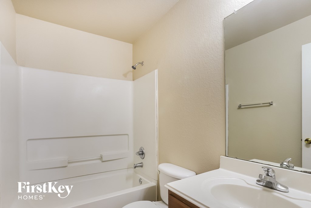 a bathroom with a sink and a toilet and a bath tub