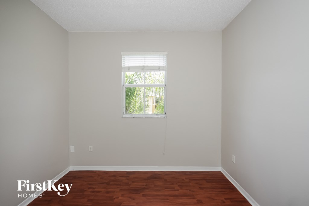 a room with a window and wooden floors