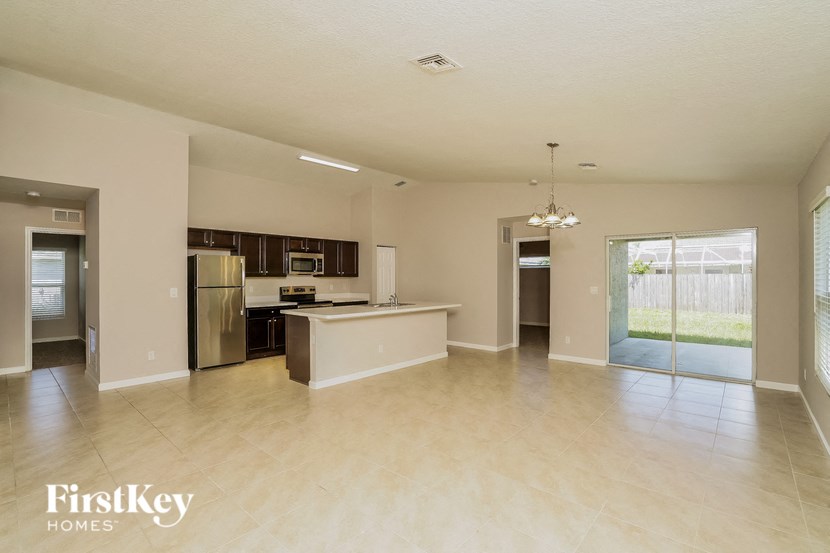 A spacious kitchen and living room with a dining area and a kitchen island.
