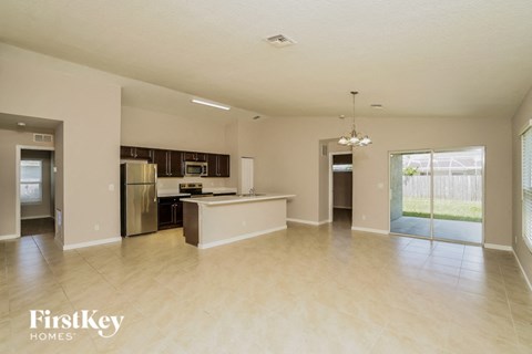 A spacious kitchen and living room with a dining area and a kitchen island.