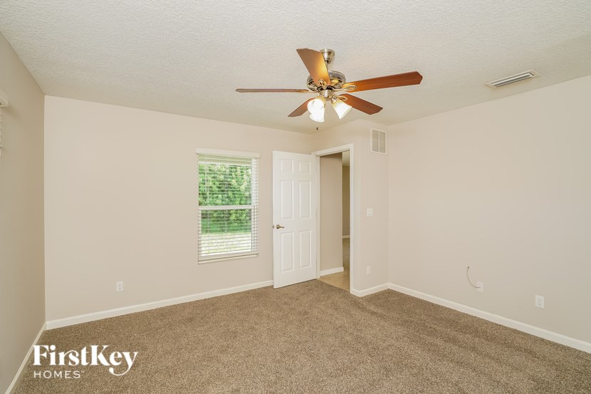 A room with a fan and a window.
