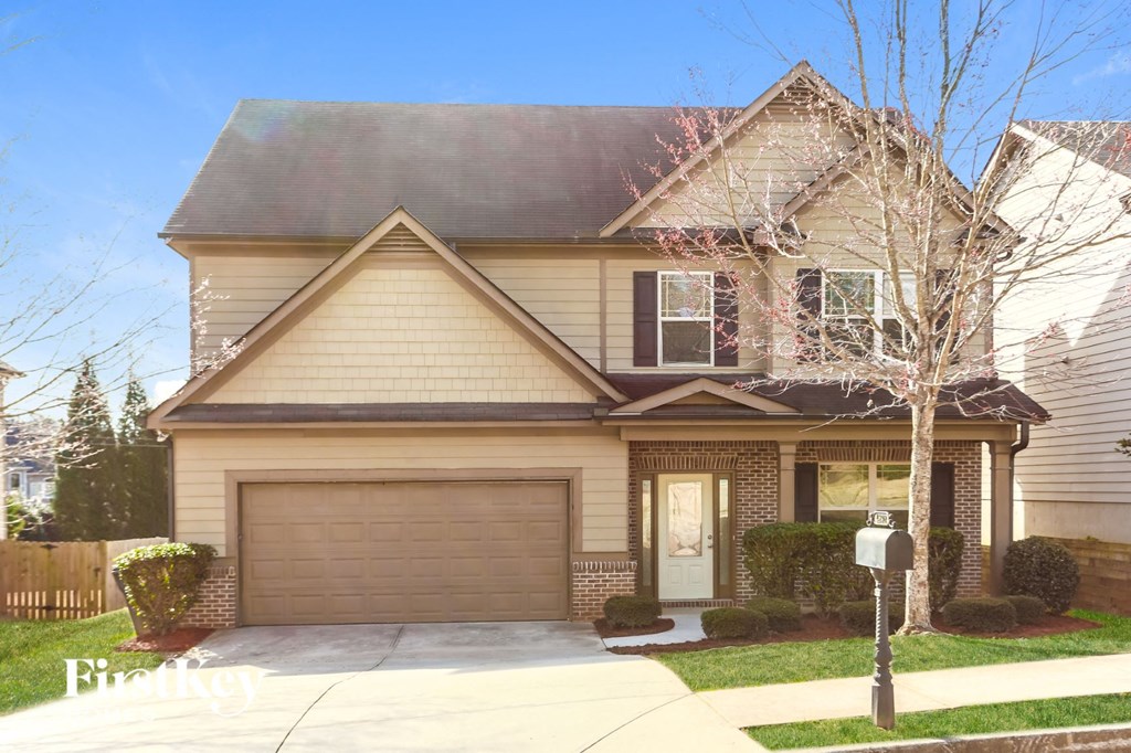 a house with a garage door in front of it