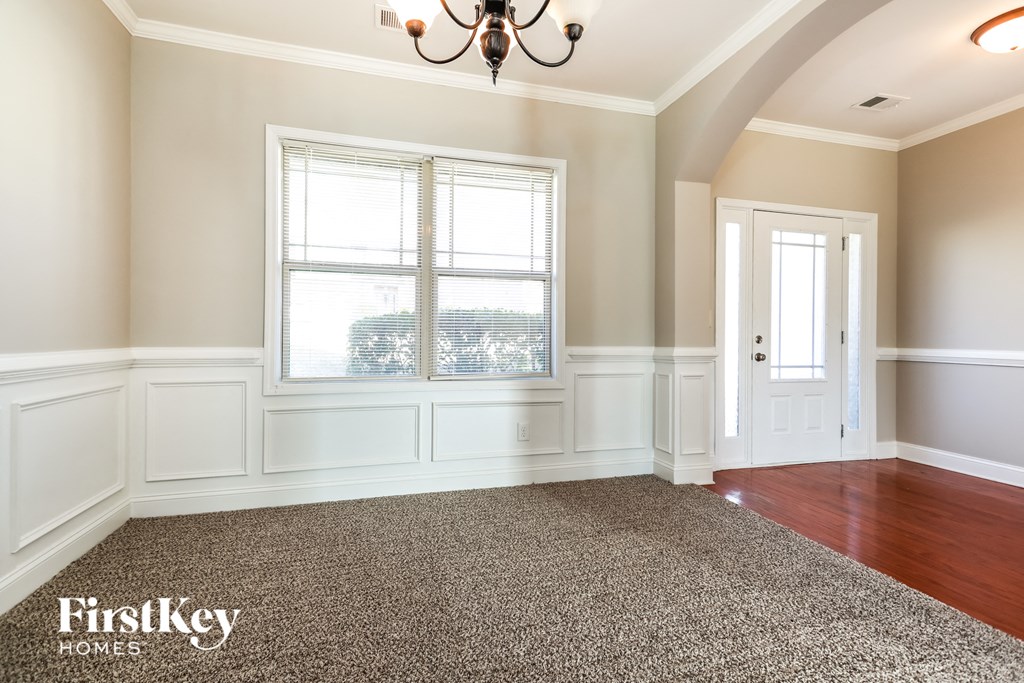 a dining room with a window and a carpet