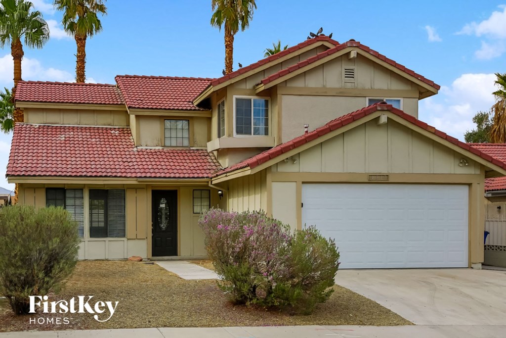 A house with a red roof and a garage door.