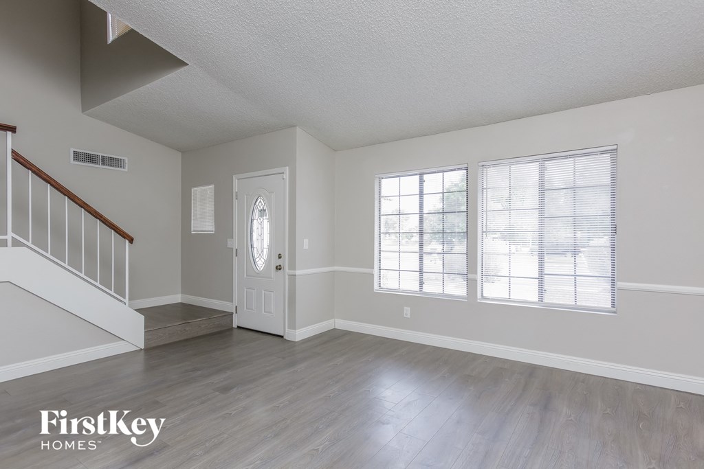 A room with a staircase and a door.