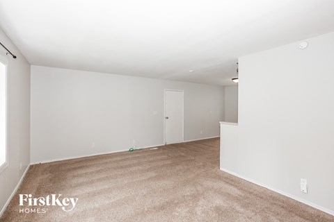 A room with a carpeted floor and white walls.