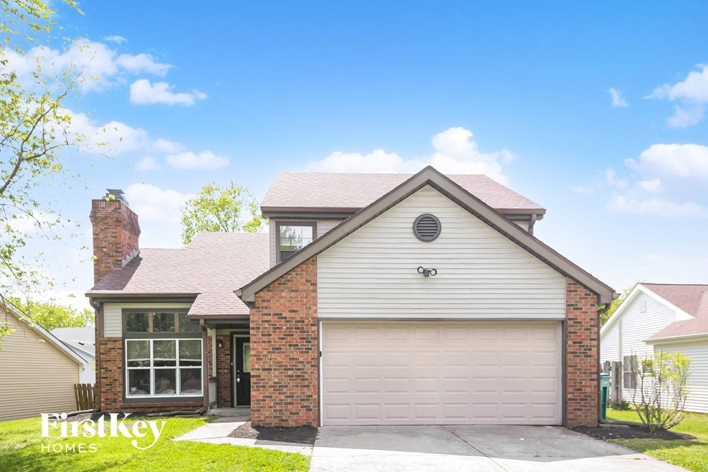 A house with a garage and a chimney is for sale.