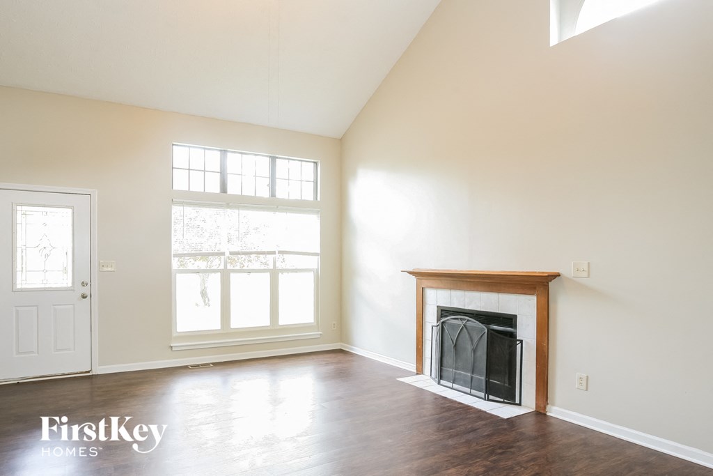 A room with a fireplace and a window.