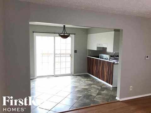 A kitchen area with a wooden counter and a window.