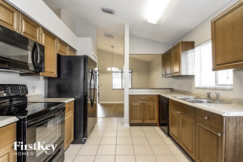 a kitchen with wooden cabinets and black appliances